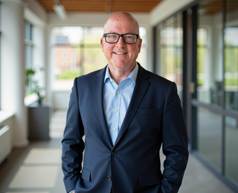 A person wearing a suit and glasses

Description automatically generated with low confidence