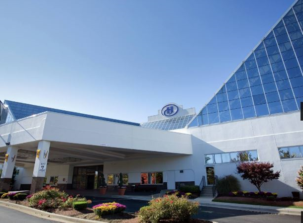 A building with a triangular roof

Description automatically generated