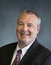 A person in a suit smiling

AI-generated content may be incorrect.