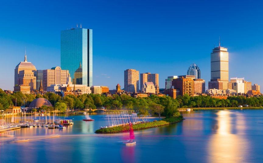 A city skyline with boats on water

Description automatically generated