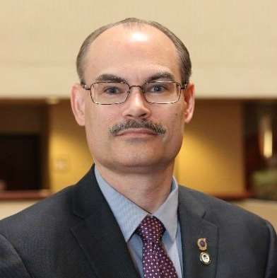 A person in a suit and tie

Description automatically generated