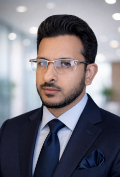A person in a suit and tie

Description automatically generated