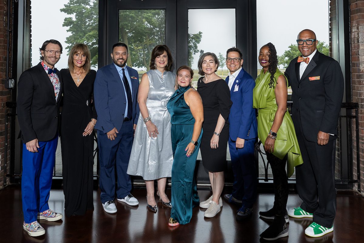 Nine Association Forum leaders standing together at an evening event in Chicago