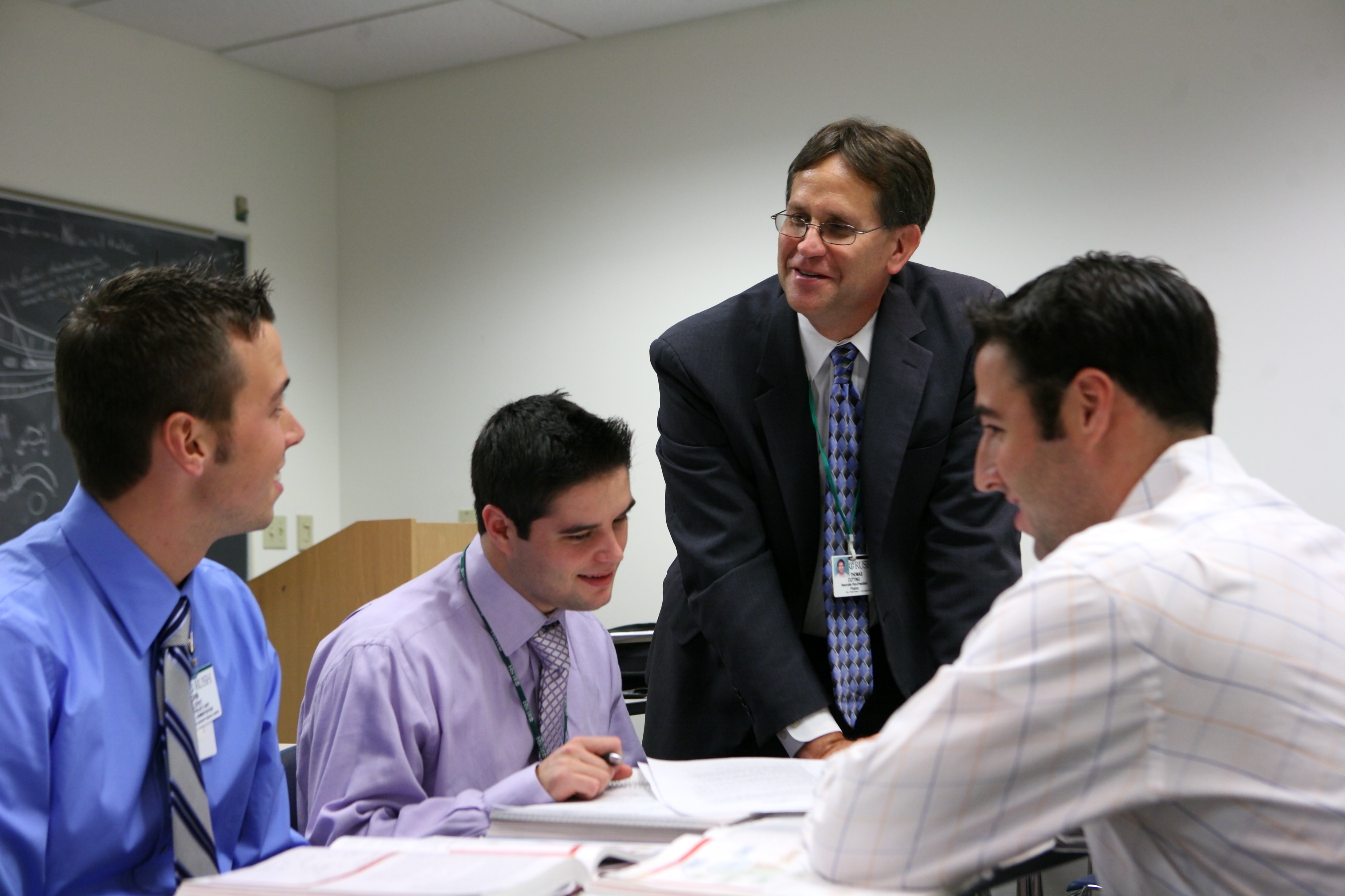 Health administration students working with a professor