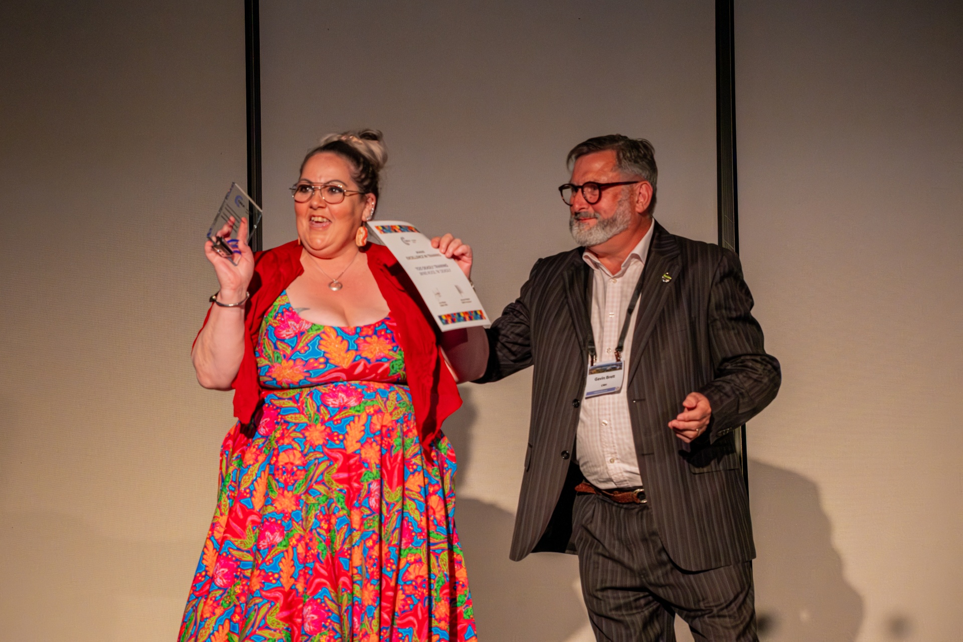 A person receiving an award from a presenter at the Community Broadcasting Awards