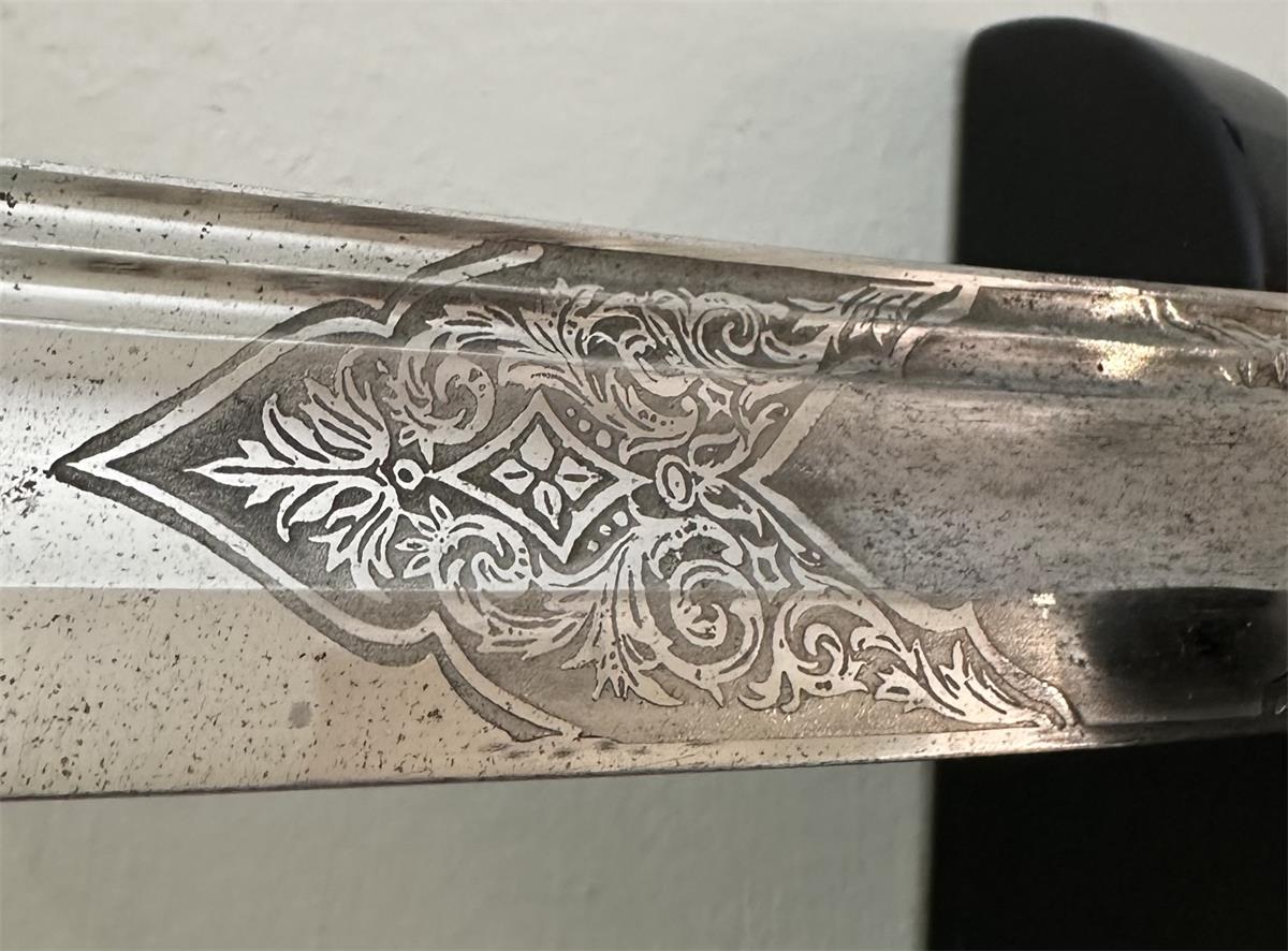 The etched section of the nickel-plated sword blade showing the signs of corrosion.