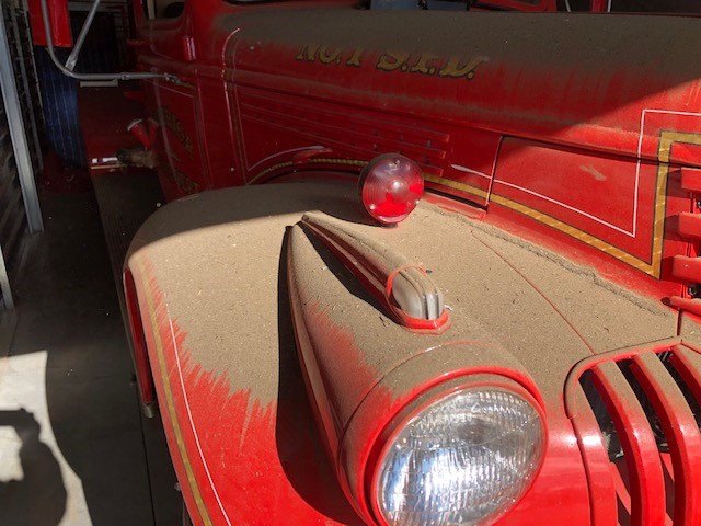 Image showing front of fire truck covered in soot.