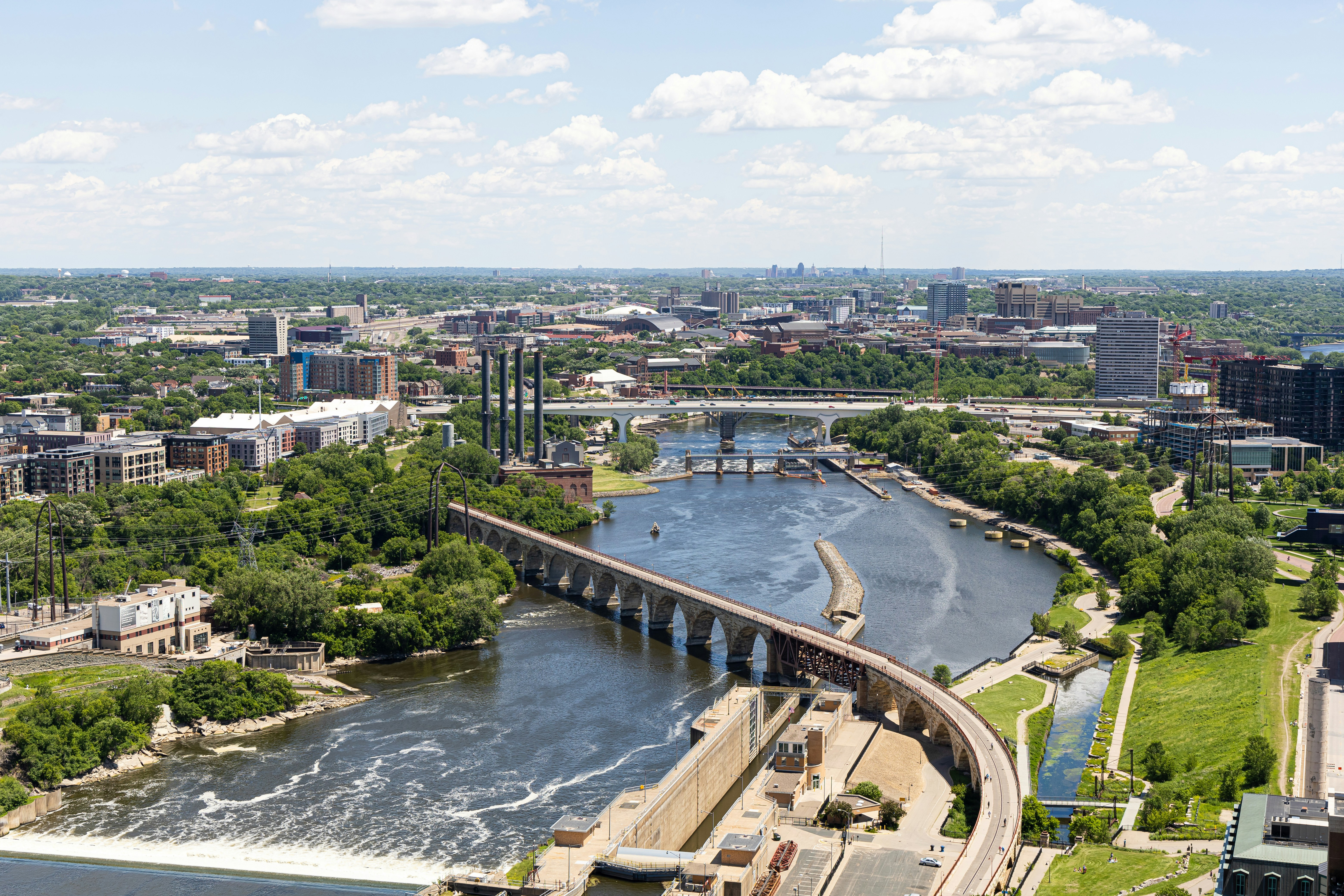 River running through landscape and city buildings