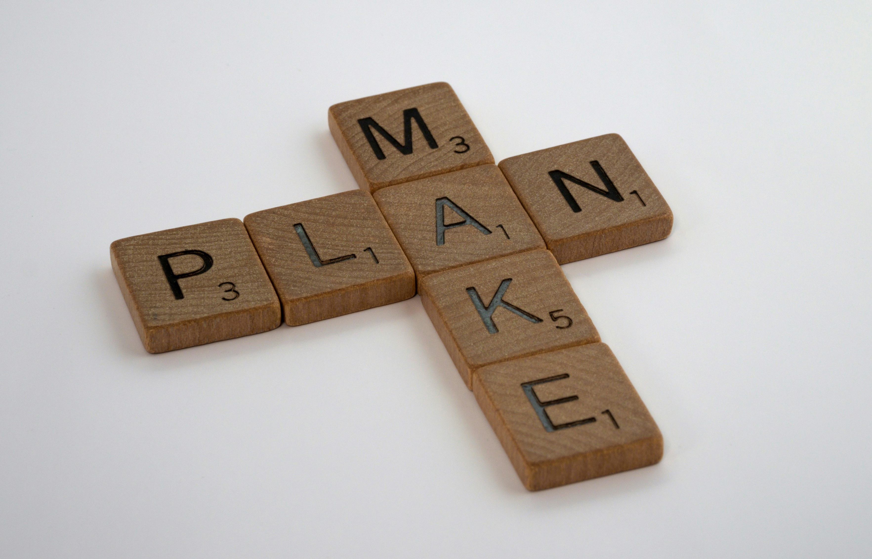Image of letter tiles spelling the words "make" and "plan".