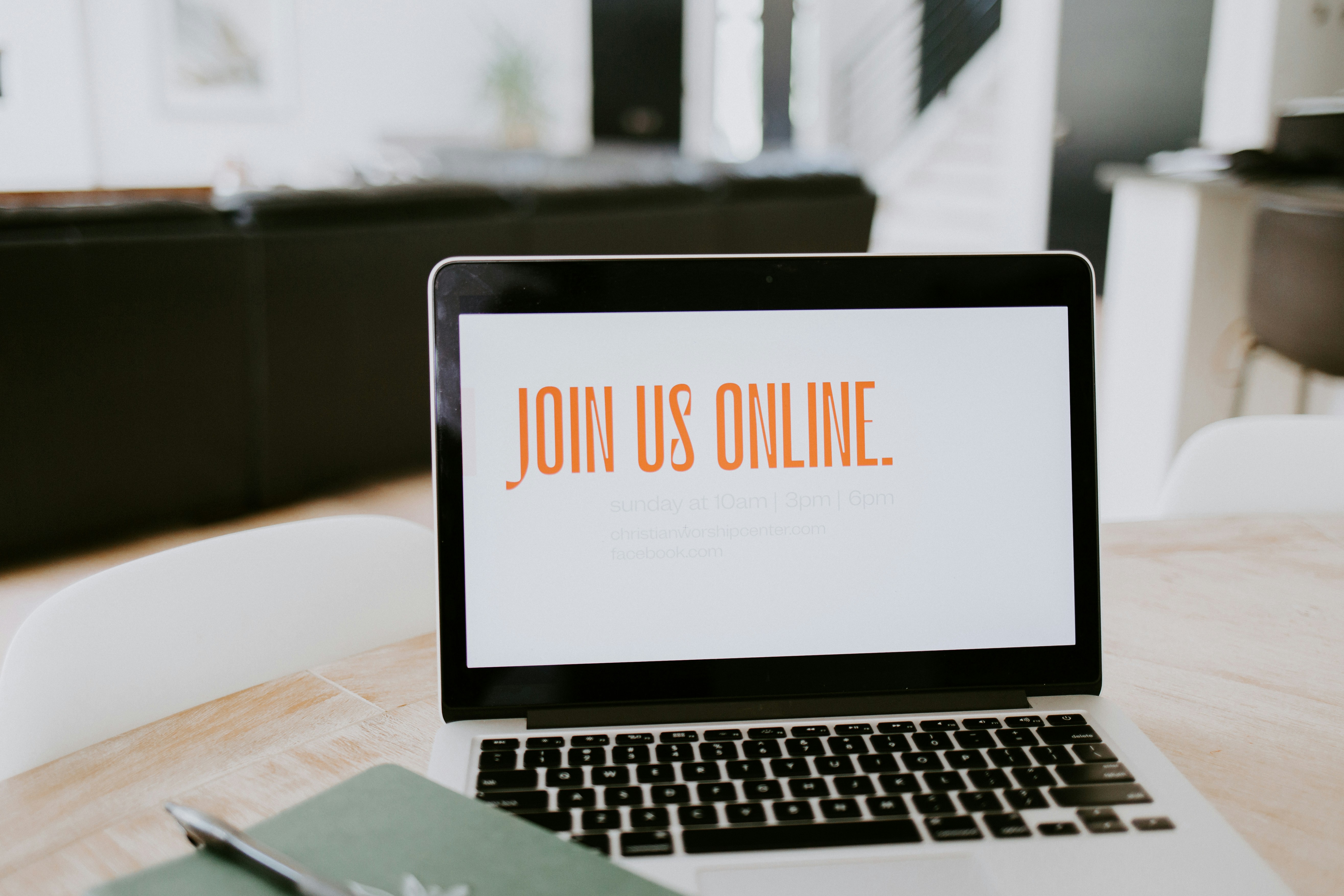 A laptop with the words "Join us online" on the screen