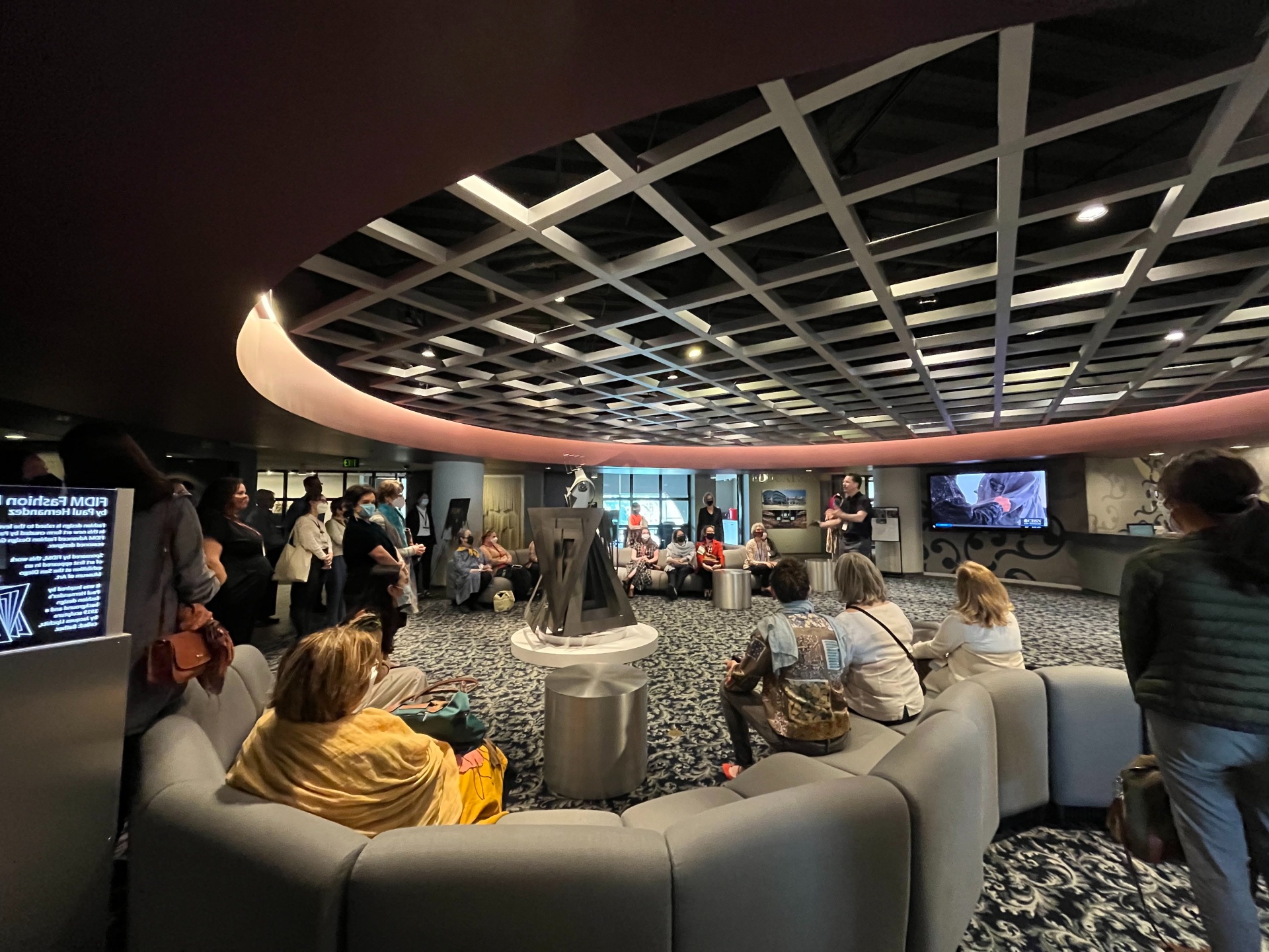 Group sitting in textiles museum