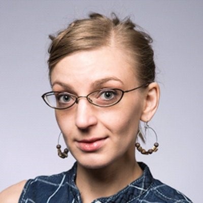 Headshot of a woman with blond hair and glasses