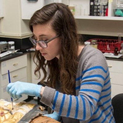 Photo of a woman with long brown hair and glasses