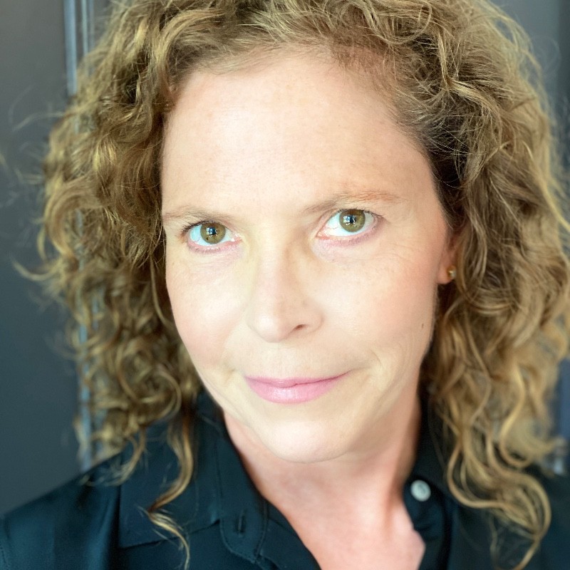 Headshot of a woman with curly hair