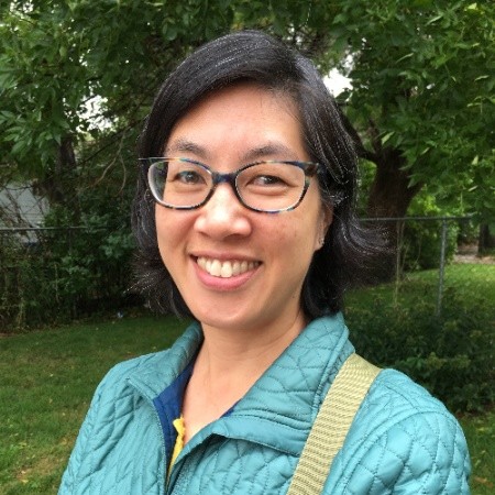 Photo of woman with short brown hair and glasses