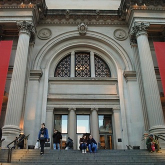 Arched stone entrance to a large building representing in institution