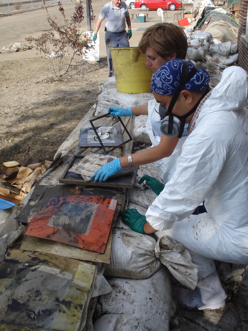 A few people wearing PPE working with collections.