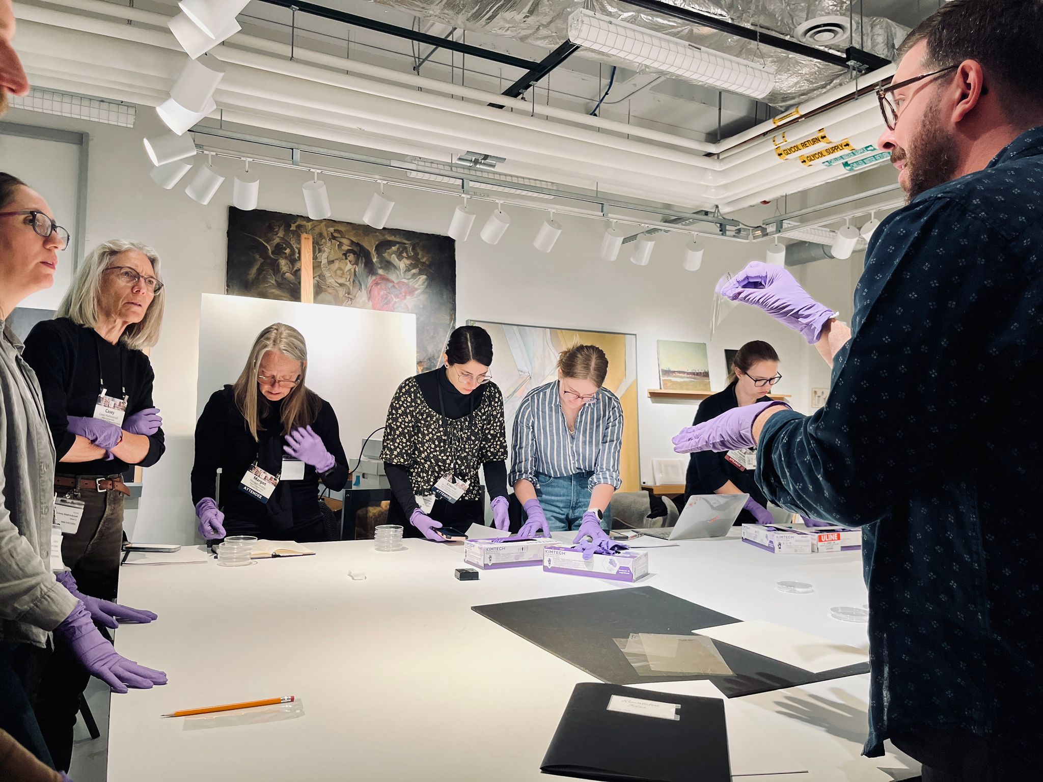 An instructor holding up an object for the group to view