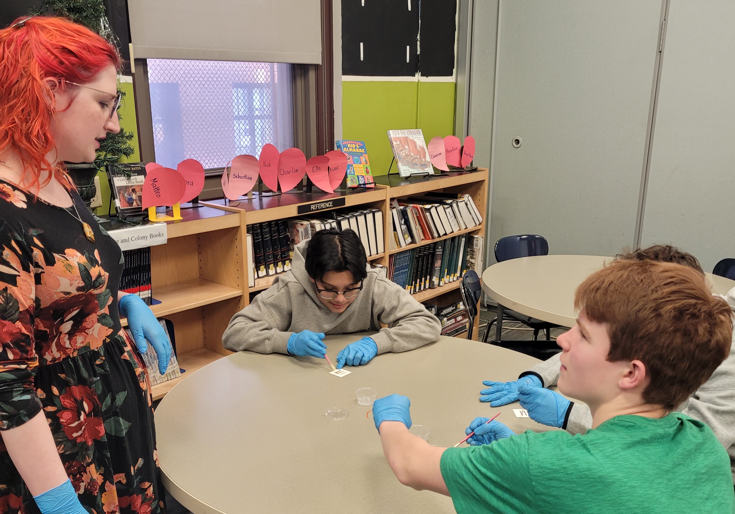 Students wearing nitrile gloves talking with a conservator