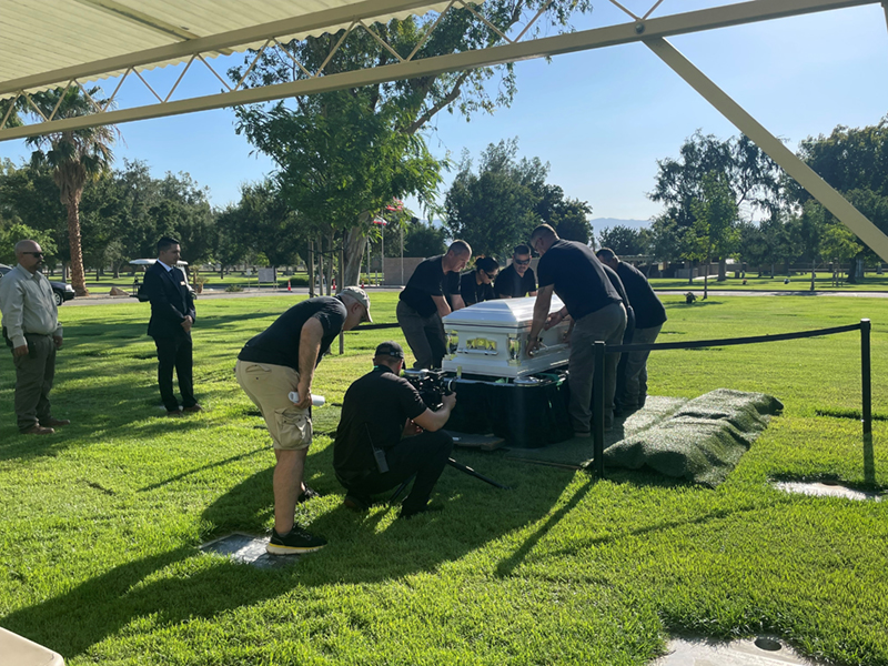Cemetery District employees film the burial process