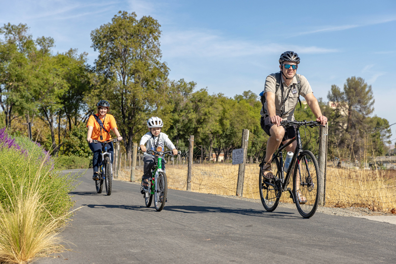 Family on a bicycle ride along a trail.
