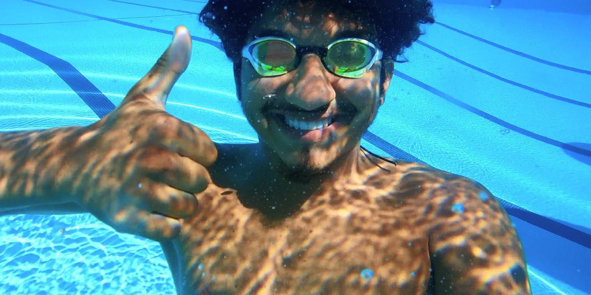 Man underwater gives thumbs up