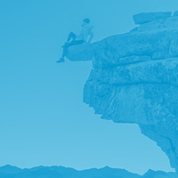 Graphic of a person sitting on top of a mountain.