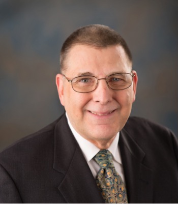A person wearing glasses and a suit

AI-generated content may be incorrect.