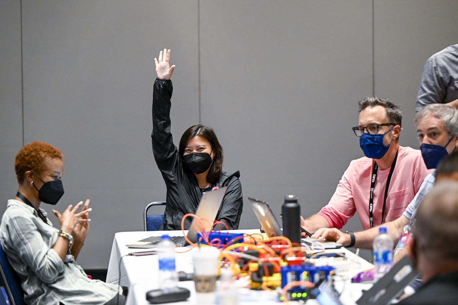 Teacher raising her hand while in a professional development session