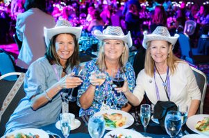 A group of women wearing cowboy hats and drinking wine

AI-generated content may be incorrect.