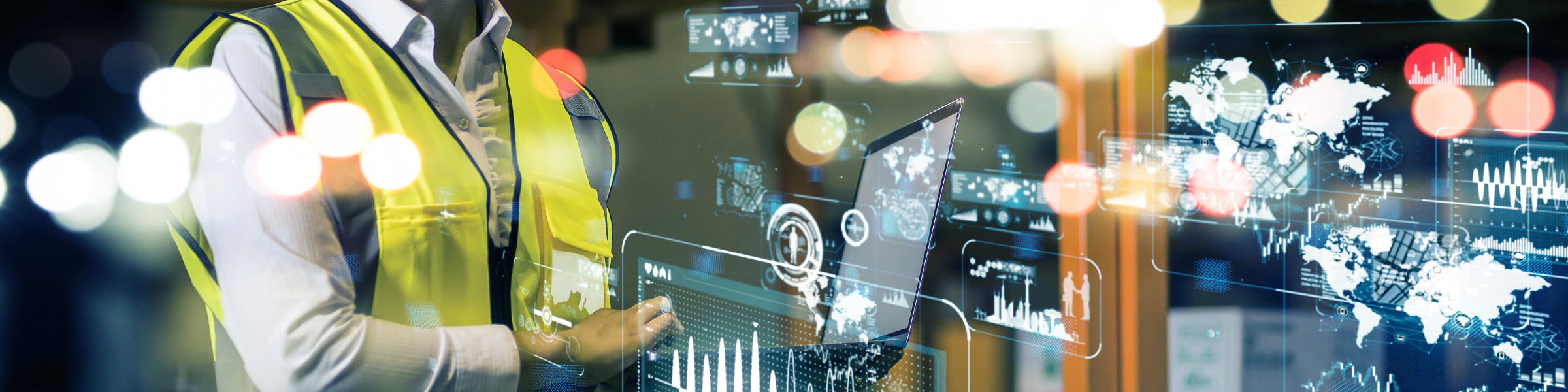 Image of worker in vest at computer