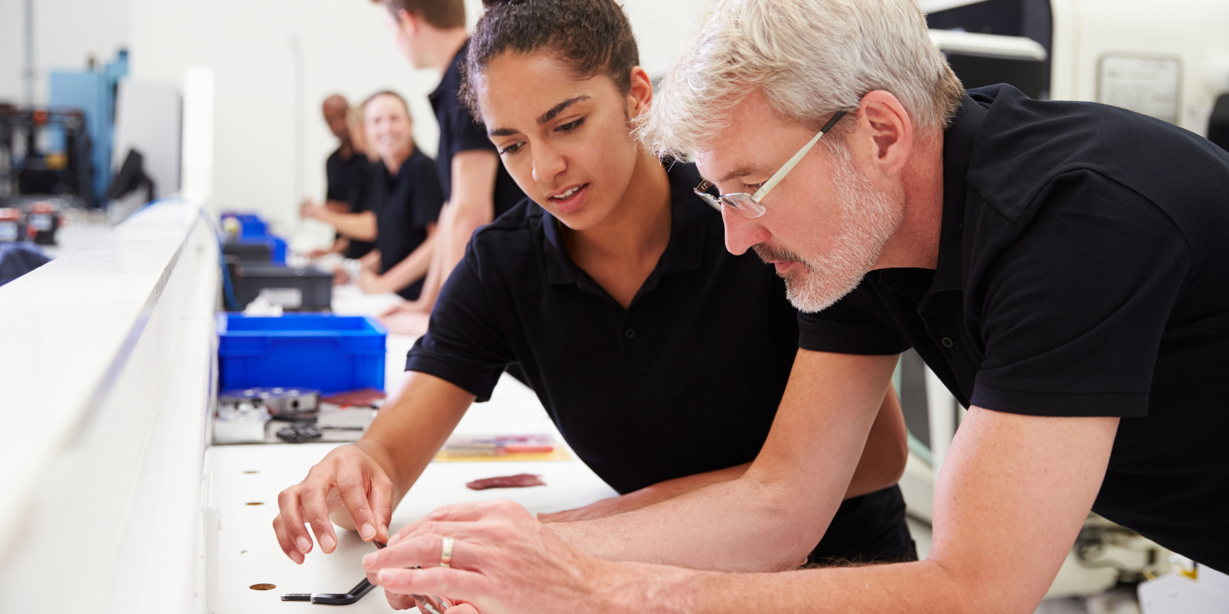 a student with an educator looking at some work