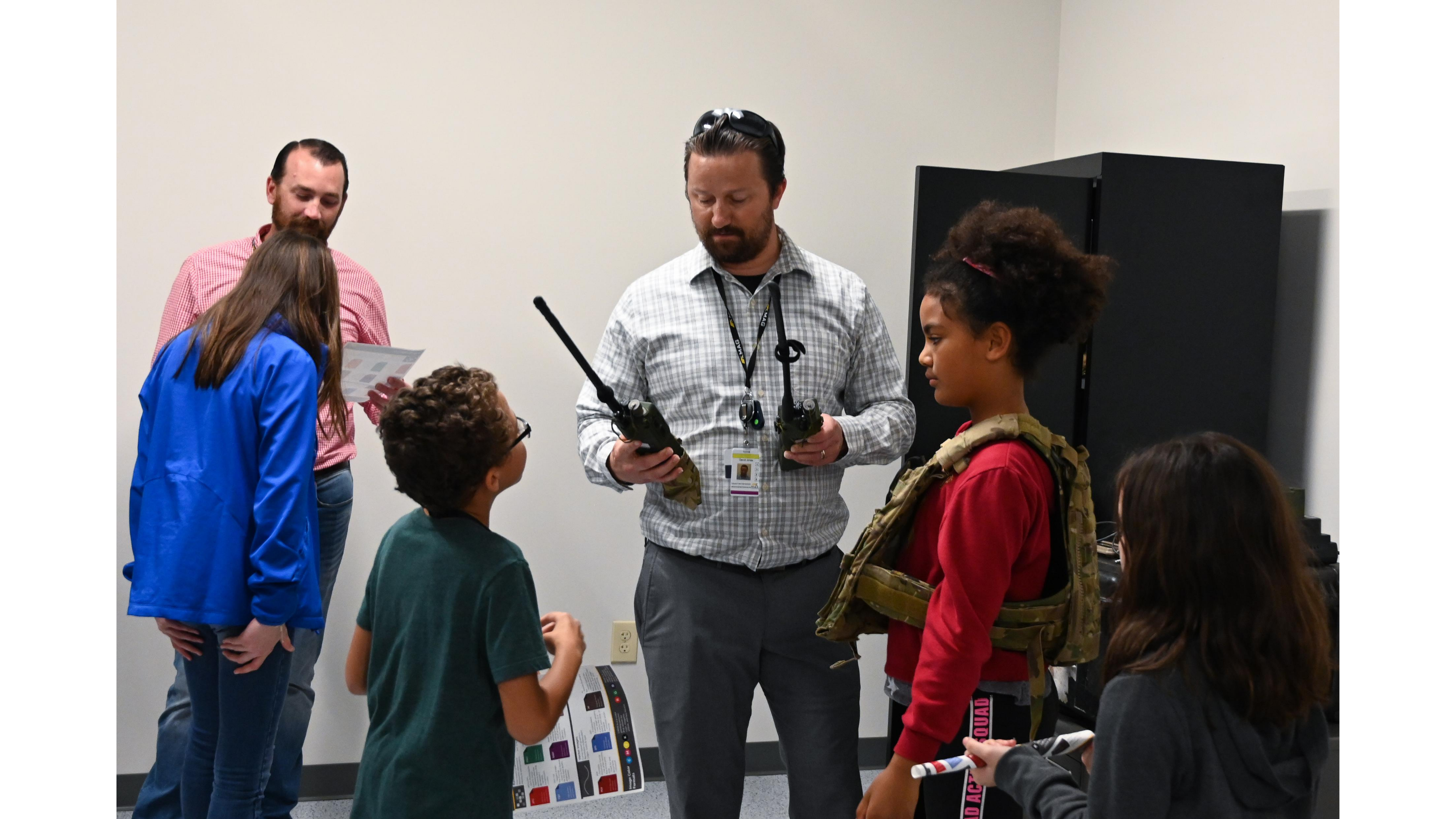 Children waiting to be handed large radios from MAG employee.