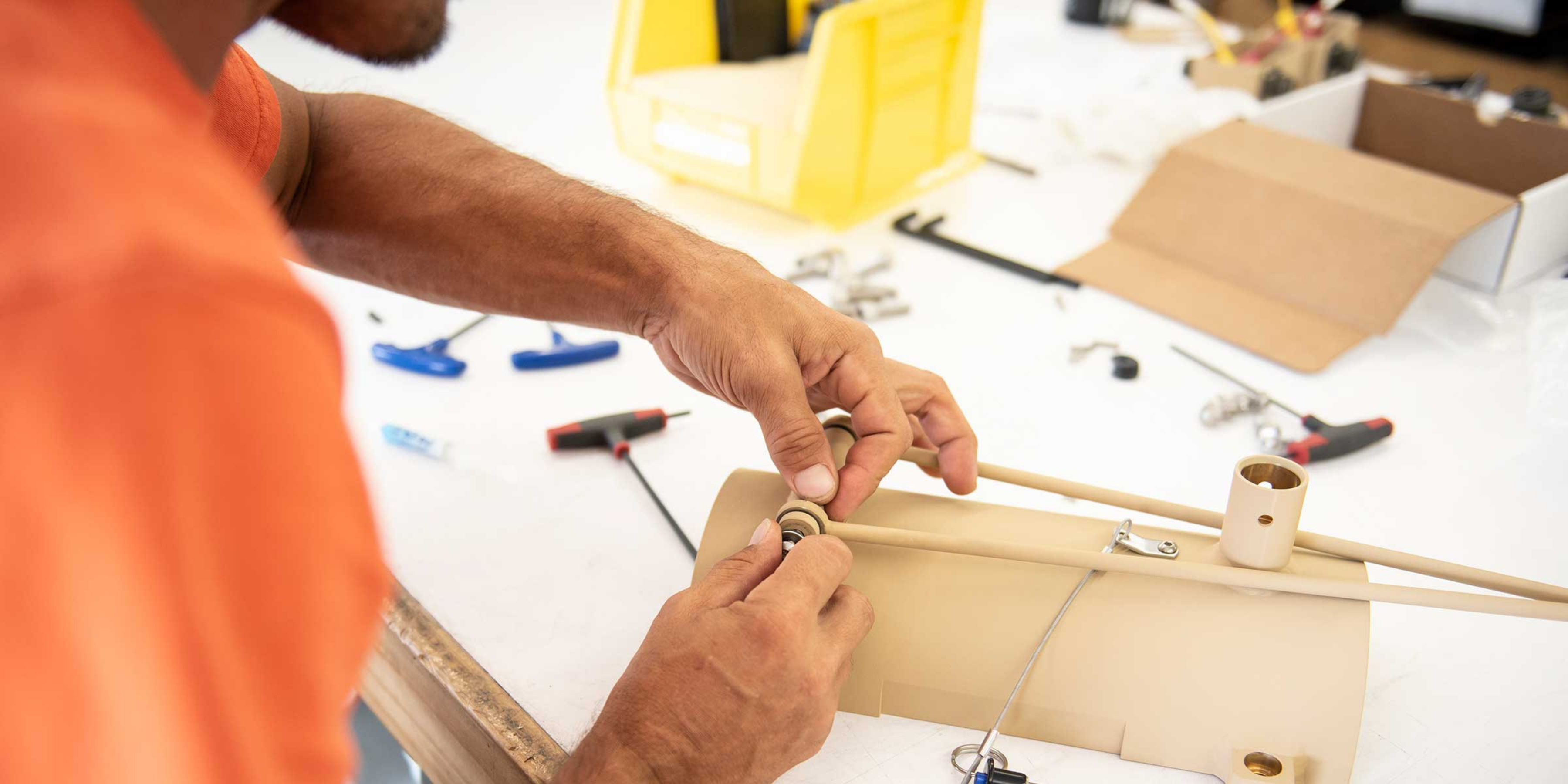 Hands working on a piece from solar panel.