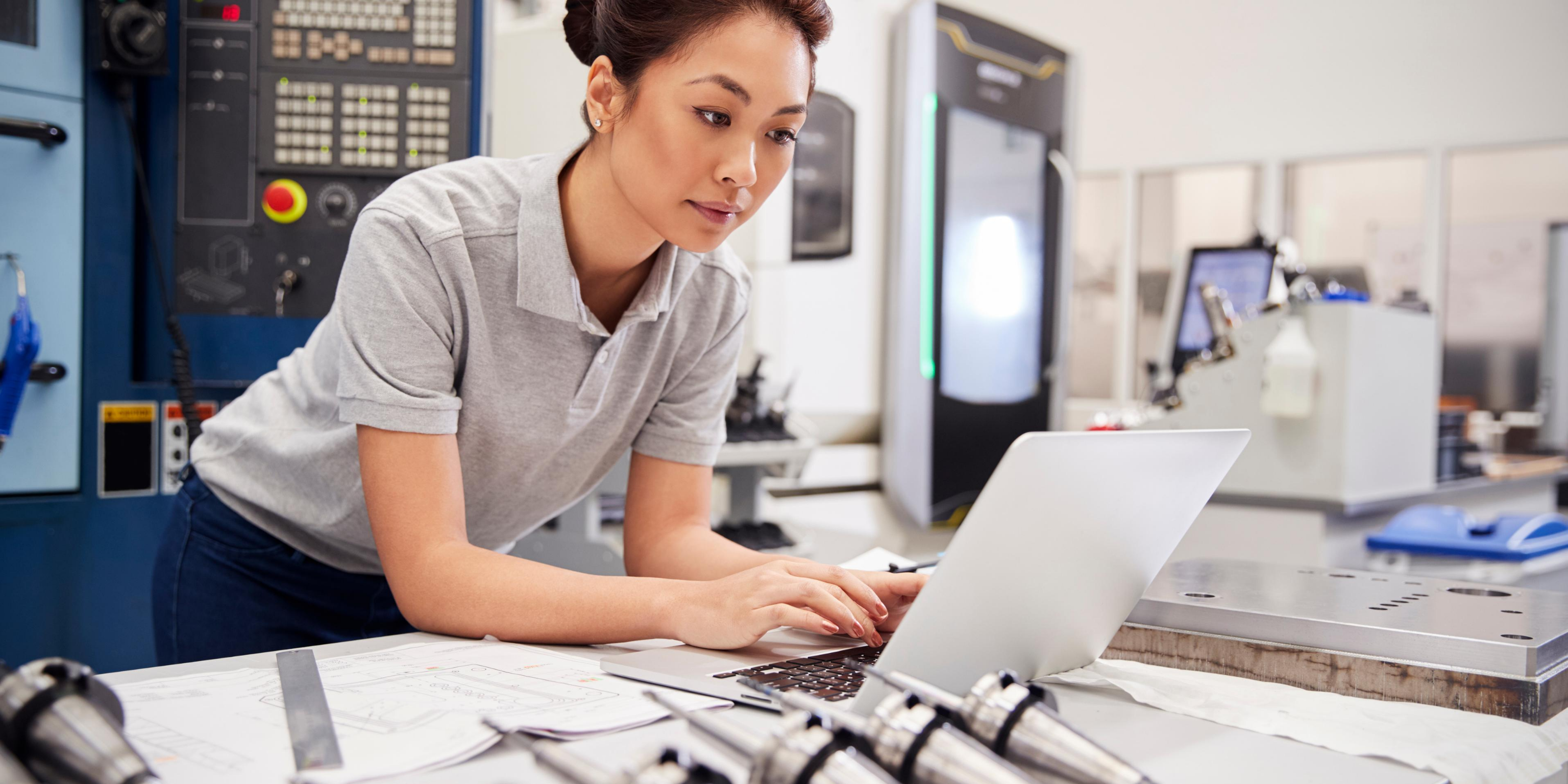 Woman working on a laptop in a laboratory