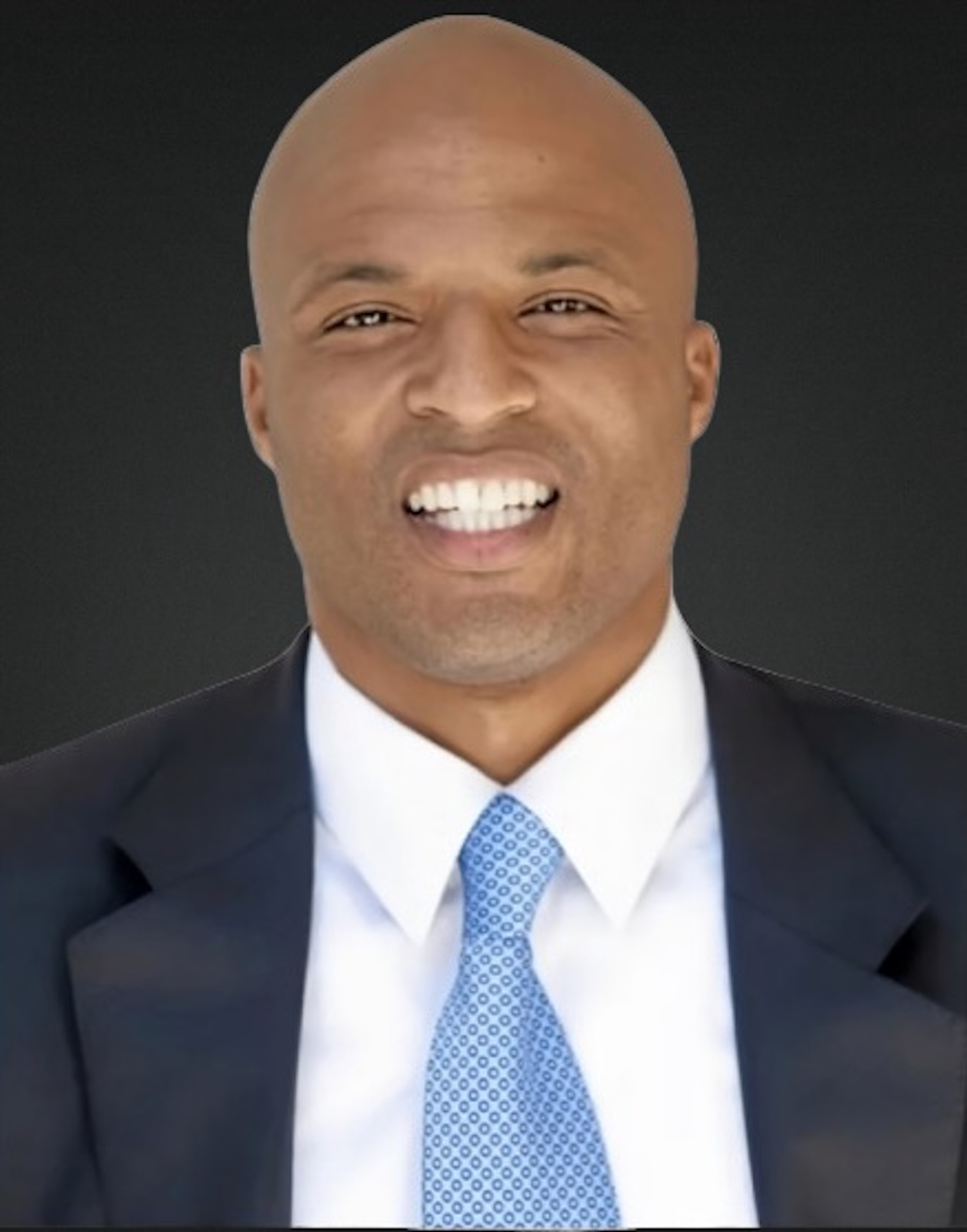 man with brown skin no hair big smile