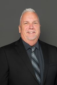 white man light gray hair smiling