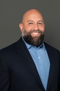 white male, no hair on head - only on face, smile