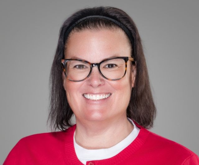 woman light skin short dark hair glasses