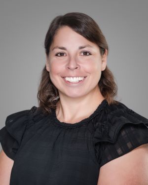 woman brown hair black blouse light skin