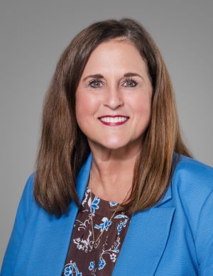 Woman brown hair blue jacket light skin