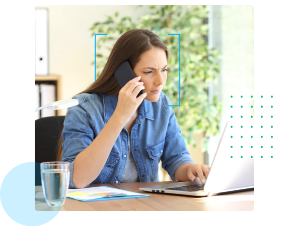woman on phone in front of computer