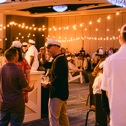 people talking at an evening event
