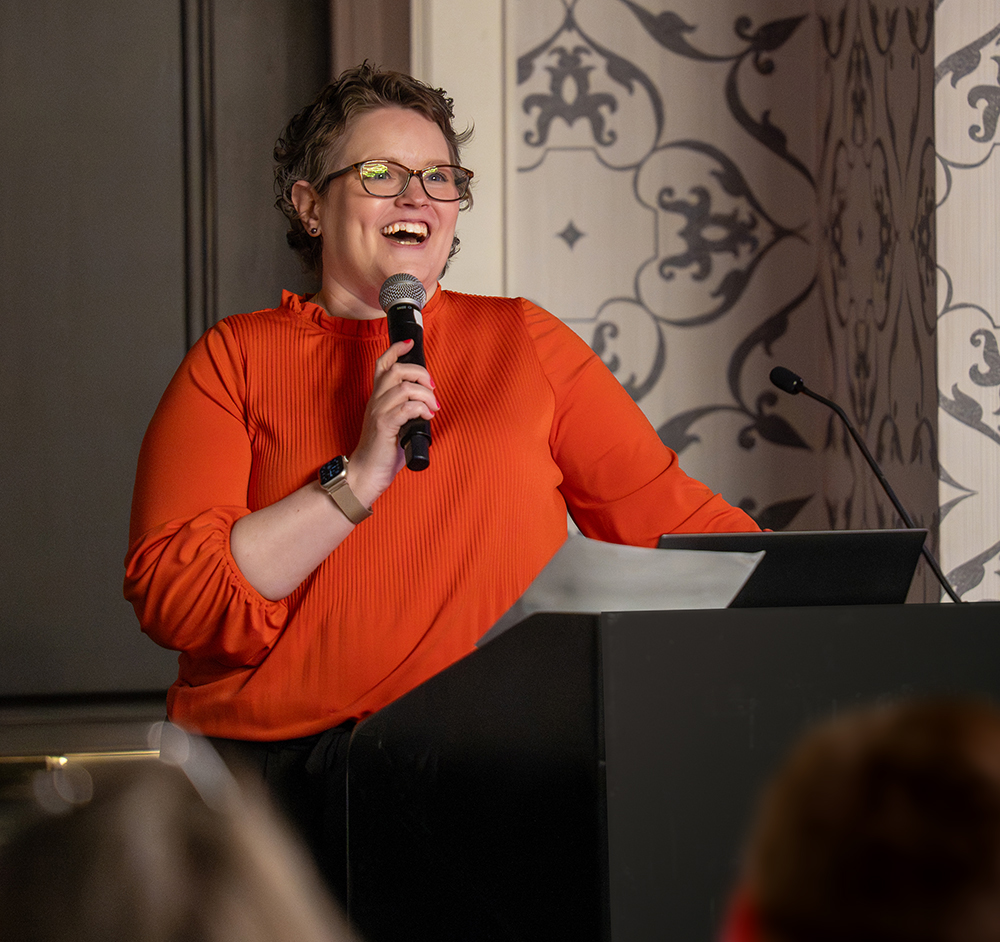 Kristen speaking to attendees during a past Super Forum session