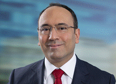 A person in a suit and tie
<br>
Description automatically generated