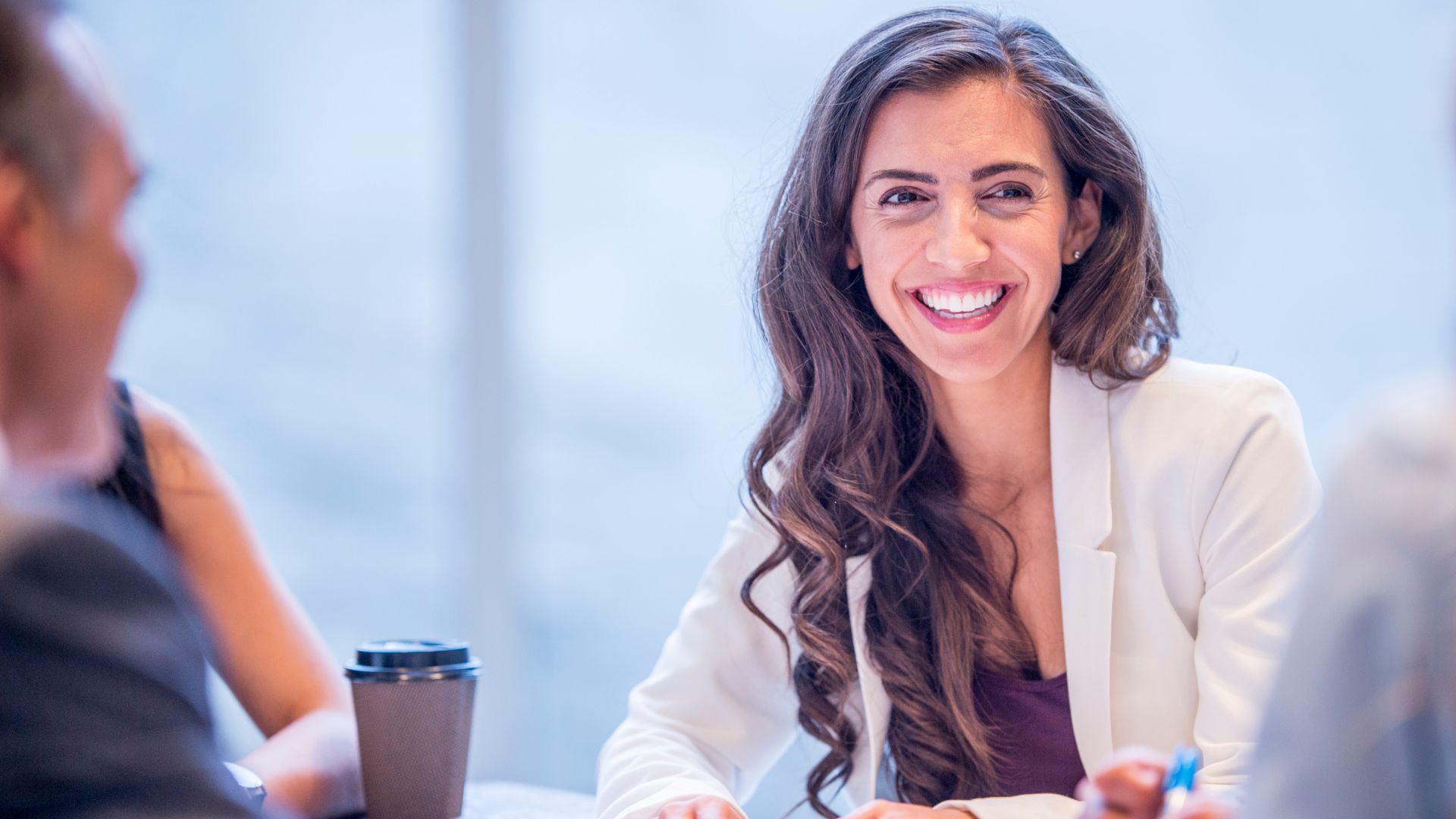 Warm corporate professional with coffee