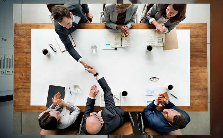 Business meeting overhead view of professionals gathered around a table