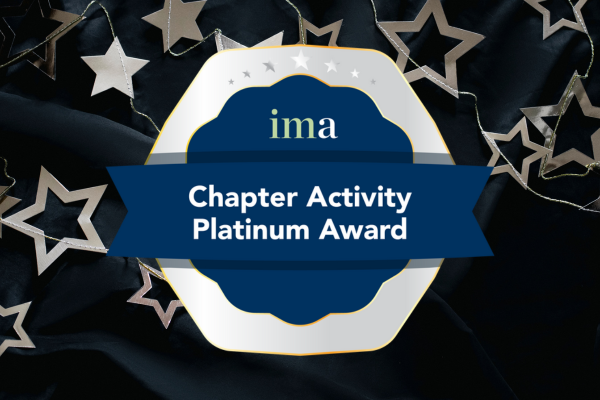 A platinum badge of excellence against a background of dark cloth and silver stars