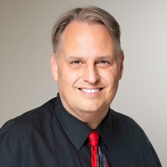 A person smiling at the cameraAI-generated content may be incorrect.