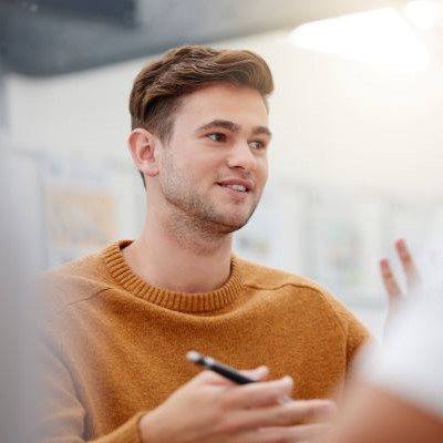 Young male wearing an orange sweater
